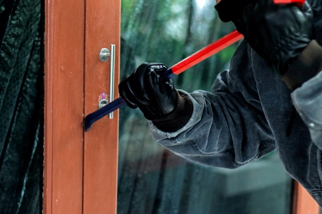 burglar with crowbar trying break door enter house 35071 971