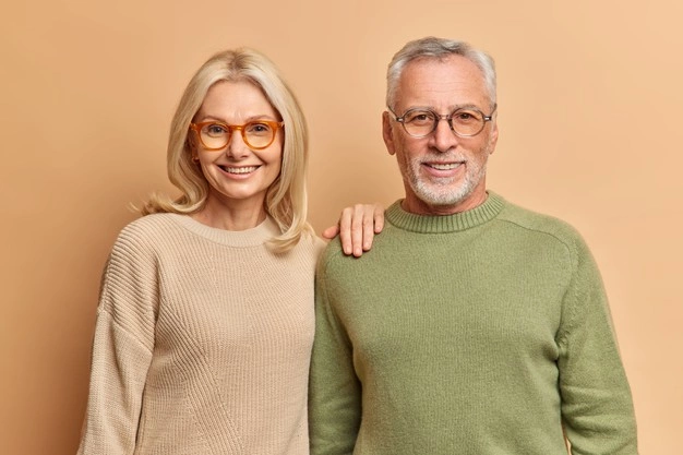 LIFE ASSURANCE 1 half length shot pleased middle aged woman man smile pleasantly wear jumpers spectacles 273609 46001