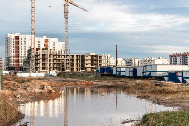 large puddle after rain construction site large residential facility reflection water construction site cranes against background sunset sky 331695 2036