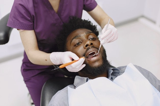 MEDICAL AID 1 young african american man guy visiting dentist s office prevention oral cavity man famale doctor while checkup teeth 1157 42084