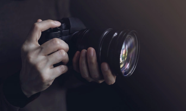 young photographer woman using camera taking photo dark tone selective focus hand 34048 997